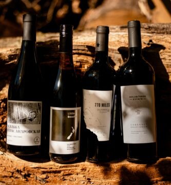 a group of wine bottles sitting on top of a wooden table