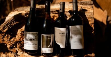 a group of wine bottles sitting on top of a wooden table